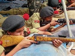 Cadets undergoing training in firing at the NCC integrity camp at Attur Jnanaganga Residential School near Kushalnagar.