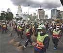Bangkok municipal workers sweep the grounds in Lumpini park, where anti-government protesters stayed for two months to clean in downtown Bangkok on Friday. AP