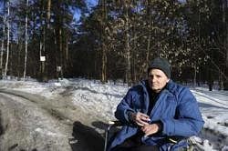 Brave crusader: Mikhail Beketov sits in a wheelchair outside a hospital on the outskirts of Moscow. NYT