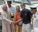 Vice-President Hamid Ansari shakes hands with Commander Dilip Donde, the first Indian to undertake solo circumnavigation of the globe on a sail boat, on his arrival in Mumbai on Saturday. PTI Photo