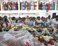 Relatives grieve next to the bodies of victims who died in  Air India Express plane crash in Mangalore, on Sunday. AP