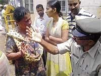 Desperate: Diana Fernandes talks to a policeman about her brother-in-law. DH Photo