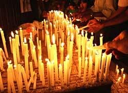 Mourners light candles during a vigil for the victims of Air India crash in Mangalore on Monday. AFP