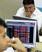 Angst & anxiety: Worry writ large on the face of brokers trading at a brokerage firm in Mumbai on Tuesday. AFP