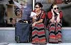 OFF duty: Air India air hostesses sit outside the domestic airport as part of a strike in New Delhi on Tuesday. Reuters