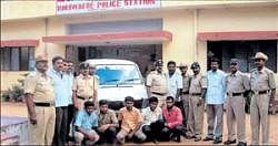 Circle Inspector of Police K B Vishwanath, SI Niranjan Kumar and other police personnel are seen with the arrested in Turuvekere. DH Photo