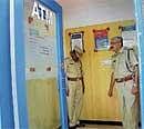 Gone In 30 Minutes:  Bangalore rural SP Mahesh and DySP Shankarappa inspecting the HDFC ATM centre on Mirza Road in Anekal on Tuesday. DH Photo