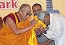 Bihar Chief Minister Nitish Kumar seeks blessings of Tibetan spiritual leader Dalai Lama during the inauguration of Buddha Smriti Park in Patna on Thursday. PTI