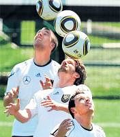 Can they deliver?: Germanys Lukas Podolski (left), Arne Friedrich (centre) and Piotr  Trochowski train at the Italian city of Appiano. AP