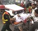 Volunteers carry a Pakistani injured in an attack, outside Garhi Shahu mosque in Lahore, Pakistan, Friday.  AP