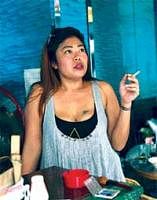 A Thai woman smokes a cigarette at a restaurant in Bangkok. AP