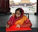 President Pratibha Patil signs the visitors book after a tour of the Forbidden City in Beijing on Friday. PTI