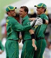 South Africas Dale Steyn (centre), AB de Villiers (left) and Johan Botha celebrate the wicket of West Indies Dwayne Bravo in Dominica on Friday. AP