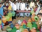 Empty pots demand water: MLA Varthur Prakash met the women from Kondarajahalli on Friday who were protesting with empty pots demanding water. DH Photo