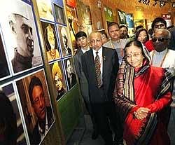 President Pratibha Patil admires photographs at the Indian Pavilion in Shanghai Expo 2010 during her visit to China on Sunday. PTI