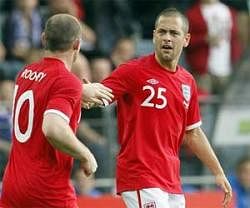 England's Joe Cole, right, and Wayne Rooney celebrate their goal during their friendly soccer match against Japan in Graz, Austria on Sunday. AP