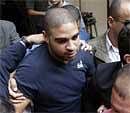 Brazil's soccer player Adriano, center, leaves the Public Ministry after being interviewed by cops on allegations of links to drug gangs in favelas in Rio de Janeiro on Wednesday. AP