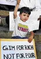 The little boy was among those who staged a protest against Global Investors Meet in front of Town Hall in Bangalore on Thursday. dh Photo