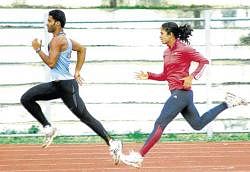 Indian athletes Rithesh Anand and H M Jyothi (right) train on the eve of the Asian Grand Prix at the  Sree Kanteerava stadium on Friday. DH PHOTO/ SRIKANTA SHARMA R