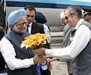 Prime Minister Manmohan Singh being received by Jammu and Kashmir Chief Minister Omar Abdullah at the technical airport on the outskirts of Srinagar on Monday. PTI