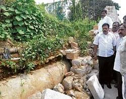 Mayor S K Nataraj looking at the collapsed wall which killed Sanjana Singh, a student, on Tuesday in Bangalore. DH Photo