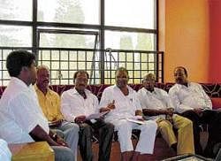 Former legislator M Bhaktavatsalam addressing a press conference at Robertsonpet on Wednesday. CMC member Dayanand is also seen. DH photo