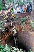 Fire brigade personnel removing the products found in the well.