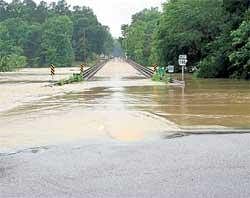 Swelling danger: High waters reach the Arkansas 240 bridge after flashfloods swamped valley campgrounds along a pair of rivers early on Friday. AP