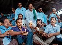 Gregory Patrao lights the torch marking the beginning of the protest to get his property back before DCs office in Mangalore on Thursday. DH Photo