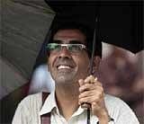 man reacts as he watches the display screen on the facade of the Bombay Stock Exchange (BSE) in Mumbai on Monday. AP