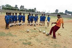Here we go: Young footballers being trained by trainer Naseer. DH Photo