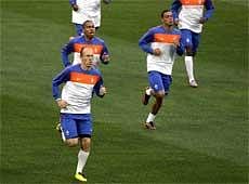 Netherlands' Arjen Robben, left, warms up with teammates during a team training session in Cape Town, South Africa, Monday. On Tuesday the Netherlands play the semifinal against Uruguay at the soccer World Cup in Cape Town. AP