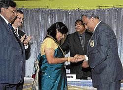 Welcome: District Governor M N Suresh installing Dr  Asha Khatri as President of Rotary Club of Bangalore on Monday. DH photo