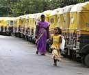A family walks past a row of auto rickshaws parked during a nationwide strike against the hike in fuel prices in Bangalore, India, Monday.  Transportation ground to a halt and businesses were closed Monday in many parts of India following a one-day strike by the main opposition parties to protest a government-imposed hike in fuel prices. AP