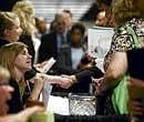 Staffing companies taking resumes from job seekers, at a job fair at the University of Phoenix in Houston. NYT