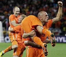 Netherlands' John Heitinga, front right, carries Wesley Sneijder, front left, as they celebrate following the World Cup semifinal soccer match between Uruguay and the Netherlands at the Green Point stadium in Cape Town, South Africa, on Tuesday. Netherlands defeated Uruguay 3-2. AP Photo