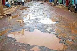 Pothole-filled  M G Road in Srinivaspur. DH Photo