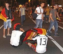 German fans react after watching the World Cup soccer match between Germany and Spain taking place in South Africa, at a public viewing area in Munich, southern Germany, on Wednesday, .AP Photo