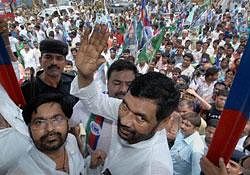 LJP chief Ramvilas Paswan waves to his party workers during the Bihar bandh against price rise, in Patna on Saturday. PTI