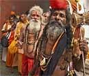 Pilgrims wait to register themselves for the Amarnath Yatra at a base camp, in Jammu on Thursday. PTI