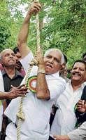 Chief Minister B S Yeddyurappa attempts rope-climbing at Sakrebailu in Shimoga district on Sunday. KPN