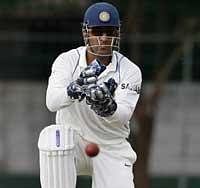 Indian cricket team captain Mahendra Singh Dhoni fields a ball during a practice match between India and Sri Lanka Board President's XI in Colombo. AP