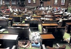 MLAs sleeping in between the Legislative Assembly seats during their continued protest against the government in Vidhana Soudha on Tuesday night. DH PHOTO
