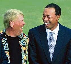 Former British Open champions Tiger Woods (right) of the US and his  compatriot John Daly share a light moment on the eve of the tournament on Wednesday. AP