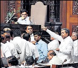 Opposition leader Siddaramaiah speaking as opposition MLAs stage a dharna for the third day at the Assembly well during the session.