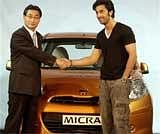Actor Ranbir Kapoor and Kiminobu Tokuyama , MD and CEO of Nissan Motor India, pose with the company's Micra car during its launch in New Delhi on Wednesday. PTI
