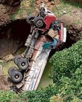 Disastrous: The ill-fated tanker which fell into a rivulet near Karad in Maharashtra. PTI