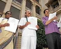 Passed: Council Opposition leader Motamma, JD(S) leaders M C Nanaiah and Y S V Datta showing the copies of Bills passed by ruling party amidst strong protest, in front of Vidhana Soudha in Bangalore on Thursday. dh photo