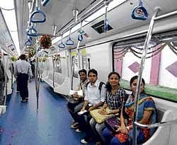 Young Bangaloreans get a feel of the Metro as they sit inside  a model coach unveiled in Bangalore on Friday. dh photo