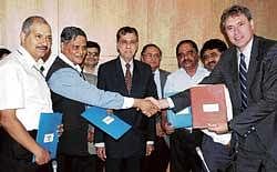 New vistas: Sector Coordinator Infrastructure and Lead Transport Specialist, World Bank, India, Den Eijbergen (right) and Joint Secretary , Anup K Pujari greet each other during signing of an MoU on Rural Water Supply and Sanitation Project in Karnataka in Bangalore on Saturday. Chief Secretary, SV Ranganath, Principal Secretary, RDPR, P Ravikumar and others are seen.  DH Photo